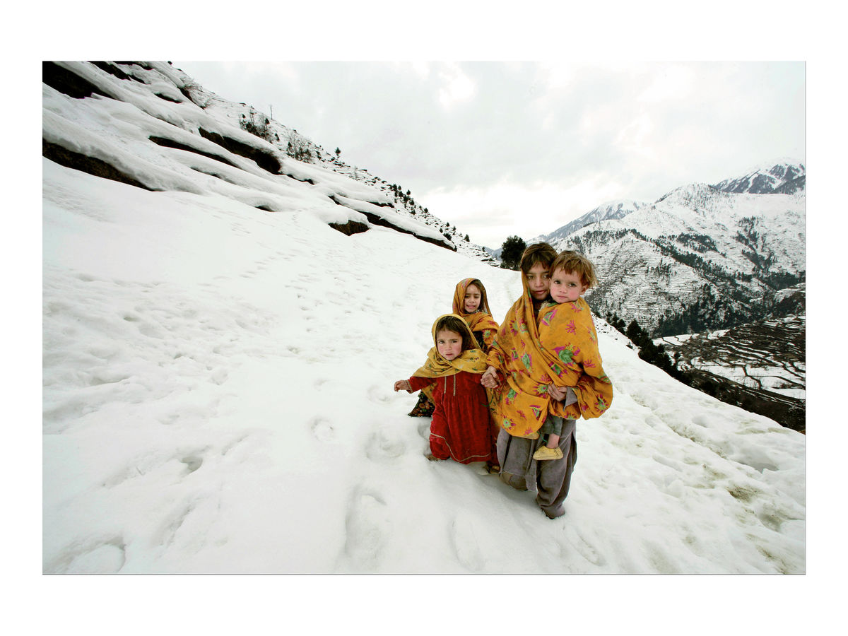 Young girls walk in the snow, Pakistan, 2006