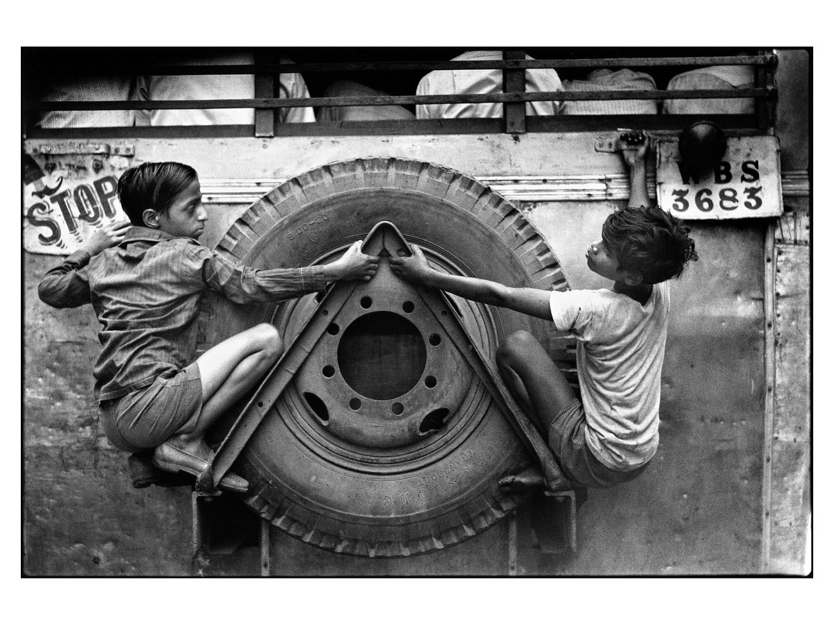 Boys clinging on to the back of a bus in Kolkatta, known at the time as Calcutta, India, 1977